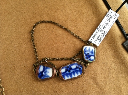 The tag attached to this necklace describes the history behind the ceramic. 